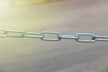 Close-up of short-link welded galvanized chain.
