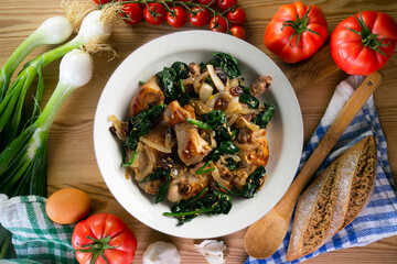 Delicious Rabbit stewed with spinach and raisins. Top view table.