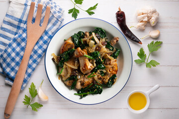 Delicious Rabbit stewed with spinach and raisins. Top view table.
