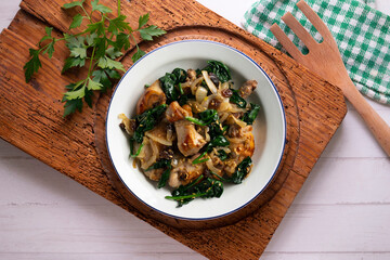 Delicious Rabbit stewed with spinach and raisins. Top view table.