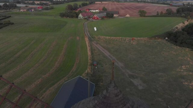Aerial view of bracke molla windmill at sunset surrounded by beautiful farmland, Nyhamnslage, Sweden.