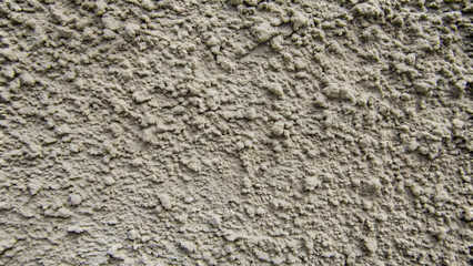 Naklejka premium An abstract close-up photo of a rough cement texture background, concrete, wall, gritty, surface, construction, material
