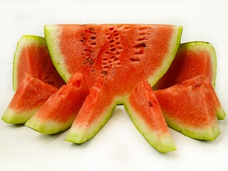 Watermelon cross section and slices of watermelon are on a white background