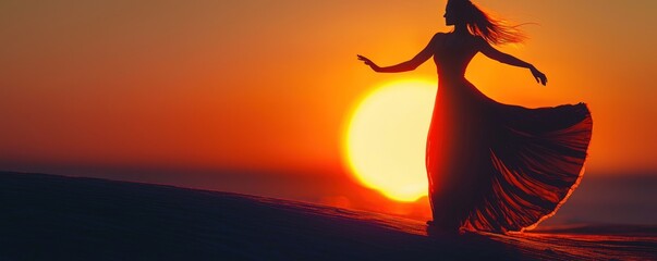 Silhouette of a Woman Dancing at Sunset in a Flowing Dress Against a Vibrant Orange Sky.