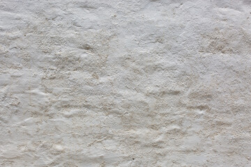 Fototapeta premium Old white wall with cracks and scratches. Abstract background for design