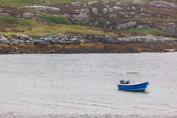 Small boat in a bay in South Uist, Image shows a bay protected from the elements along the South Uist coastline