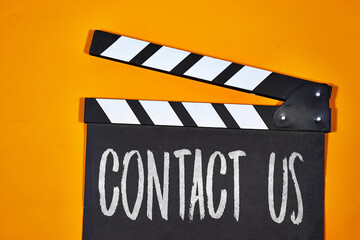 contact us concept on clapper board of video cinema in studio