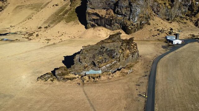 Amazing 4K drone footage of Drangurinn &iacute; Drangshl&iacute;&eth;, Iceland. Explore breathtaking aerial views of this historic rock formation and the nearby traditional Icelandic turf houses