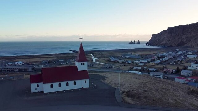 Beautiful 4K drone footage of V&iacute;k &iacute; M&yacute;rdal Church in Iceland. Enjoy stunning aerial views of this iconic hilltop church with the dramatic Icelandic coastline as a backdrop