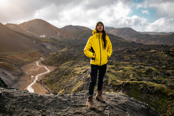 Adventurous Hiker in Yellow Jacket Exploring Mountain Landscape