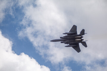 F15 fighter jet taking off with landing gear up, from a public road 