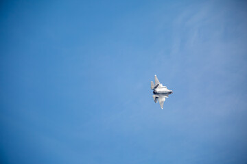 F35 Lightning flying during sunset creating wingtip vortex's, from a public road