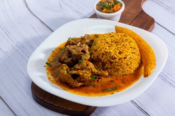 A mouthwatering dish of Seco de chivo chancho featuring a rich and savory sauce, served with tender chunks of goat, pork, and beef. Accompanied by a generous portion of moros de lenteja (lentil rice)