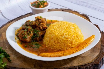 A mouthwatering dish of Seco de chivo chancho featuring a rich and savory sauce, served with tender chunks of goat, pork, and beef. Accompanied by a generous portion of moros de lenteja (lentil rice)