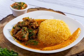 A mouthwatering dish of Seco de chivo chancho featuring a rich and savory sauce, served with tender chunks of goat, pork, and beef. Accompanied by a generous portion of moros de lenteja (lentil rice)