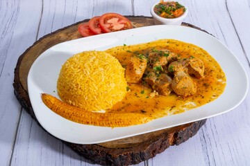 A mouthwatering dish of Seco de chivo chancho featuring a rich and savory sauce, served with tender chunks of goat, pork, and beef. Accompanied by a generous portion of moros de lenteja (lentil rice)