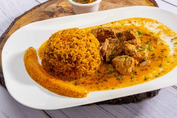 A mouthwatering dish of Seco de chivo chancho featuring a rich and savory sauce, served with tender...