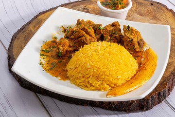 A mouthwatering dish of Seco de chivo chancho featuring a rich and savory sauce, served with tender chunks of goat, pork, and beef. Accompanied by a generous portion of moros de lenteja (lentil rice)