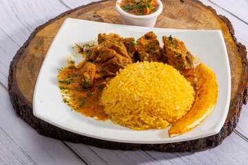 A mouthwatering dish of Seco de chivo chancho featuring a rich and savory sauce, served with tender chunks of goat, pork, and beef. Accompanied by a generous portion of moros de lenteja (lentil rice)