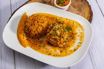 Deliciously charred and smoky Pollo a la Brasa (grilled chicken) served whole and in pieces, accompanied by crispy fries, fresh salad, and a flavorful dipping sauce. A classic Latin American dish, coo