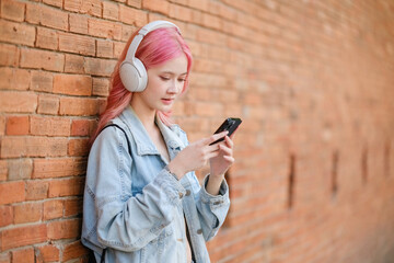 Fototapeta premium She is wearing headphones and she is listening to music