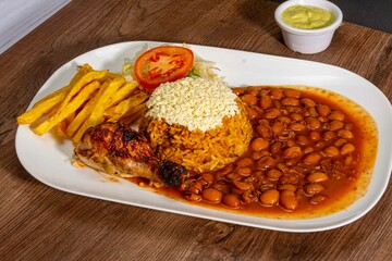 Deliciously charred and smoky Pollo a la Brasa (grilled chicken) served whole and in pieces, accompanied by crispy fries, fresh salad, and a flavorful dipping sauce. A classic Latin American dish, coo