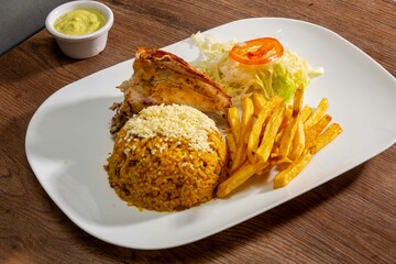 Deliciously charred and smoky Pollo a la Brasa (grilled chicken) served whole and in pieces, accompanied by crispy fries, fresh salad, and a flavorful dipping sauce. A classic Latin American dish, coo