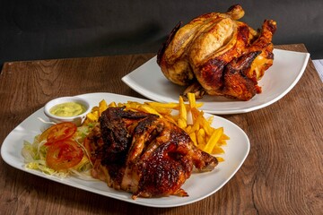 Deliciously charred and smoky Pollo a la Brasa (grilled chicken) served whole and in pieces, accompanied by crispy fries, fresh salad, and a flavorful dipping sauce. A classic Latin American dish, coo