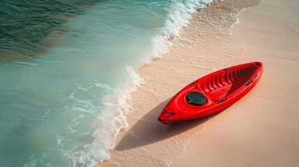 A bright red kayak resting on a soft sandy beach near gentle waves. Ideal for summer adventures and peaceful moments by the sea.