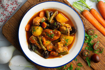 Delicious Rabbit stewed with vegetables and potatoes. Top view table with christmas decoration.