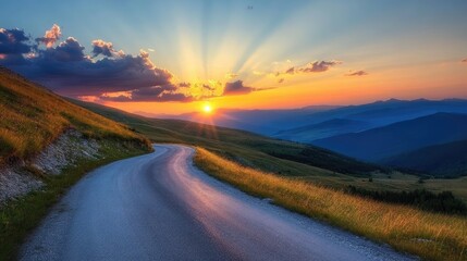 Fototapeta premium Mountain road at sunset, with dramatic colors and long shadows
