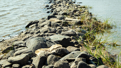 Rocky bank of a large river on a sunny day