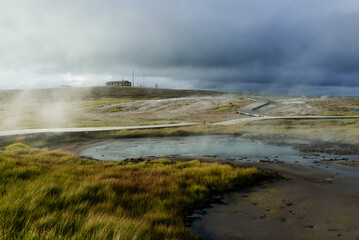 Geothermal Hot Springs in Lush Green Icelandic Landscape with Rising Steam