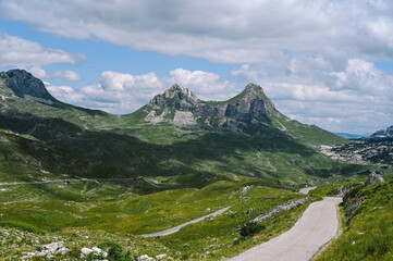 Fototapeta premium Panoramic Mountain Range and Views - Alpine style Alps in Durmitor, Montenegro - Wide Landscape Shot of epic Mountains and Roads