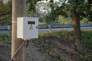 Square plastic cabinet on a post.
