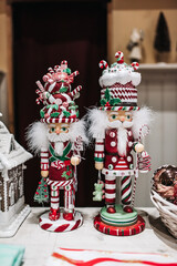 Festive Christmas Nutcrackers in Candy Cane Attire on Wooden Surface