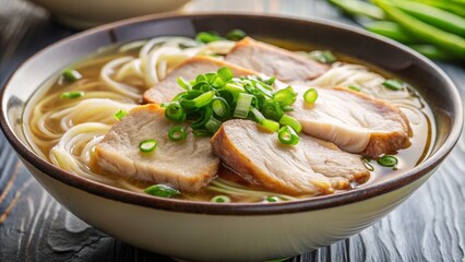 A shallow depth of field draws the viewer's attention to the tender, savory slices of pork and the delicate seaweed, suspended in the light