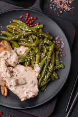 Asian food baked chicken breast with green beans, sesame seeds and sauce