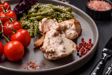 Asian food baked chicken breast with green beans, sesame seeds and sauce