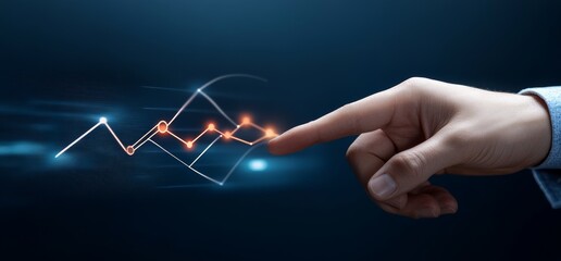Businessperson's hand pointing at upward-trending graph on digital screen