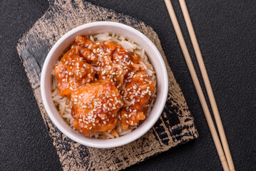 Asian food boiled rice with meat with sweet and sour sauce, spices and herbs