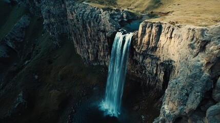 A stunning waterfall cascading down rocky cliffs into a serene pool below.