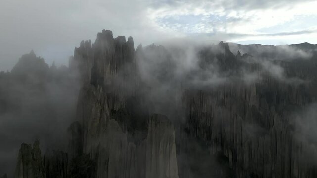 Aerial view of dramatic cliffs and majestic mountains shrouded in fog, Las Animas, Valle de las Animas, Bolivia.