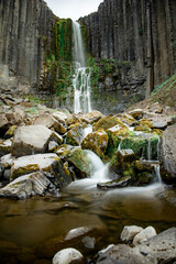 Majestic Waterfall Amidst Rocky Cliffs