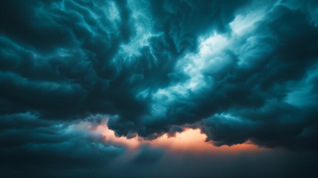 A dramatic sky filled with dark, swirling clouds, with a sliver of warm light breaking through the bottom.