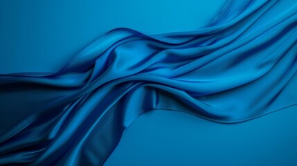 Abstract blue silk fabric flowing on a blue background.