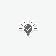 Light bulb with tick icon sticker isolated on gray background