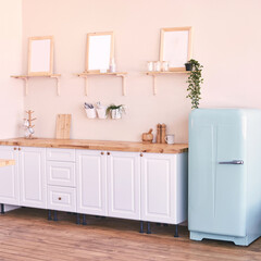 Cozy minimalist kitchen with vintage blue refrigerator and wooden shelves for contemporary home design