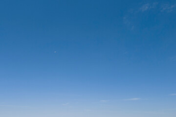 Clear blue sky with no clouds, showcasing a serene and uninterrupted horizon.