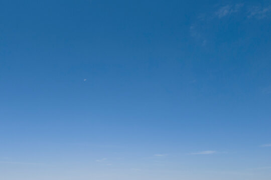 Clear blue sky with no clouds, showcasing a serene and uninterrupted horizon.
